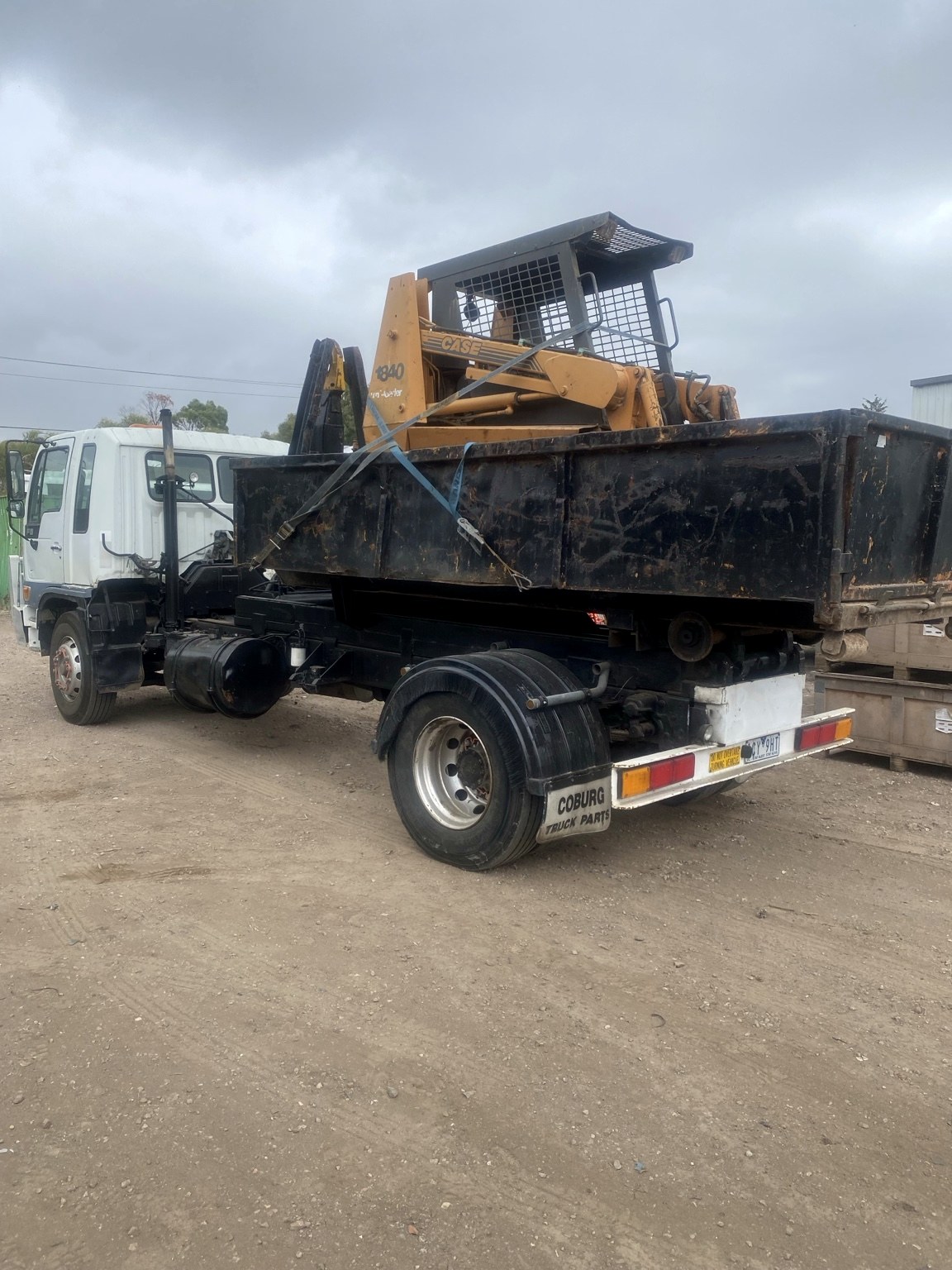 Truck transporting bobcat